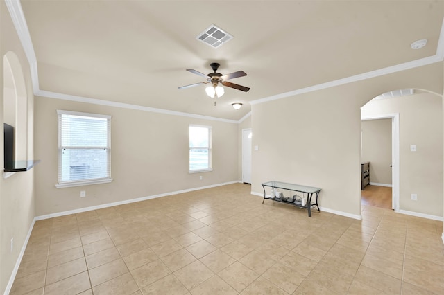 tiled spare room featuring ceiling fan and crown molding