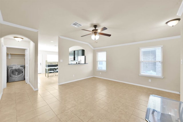 empty room featuring washer / dryer, light tile patterned floors, ceiling fan, and crown molding