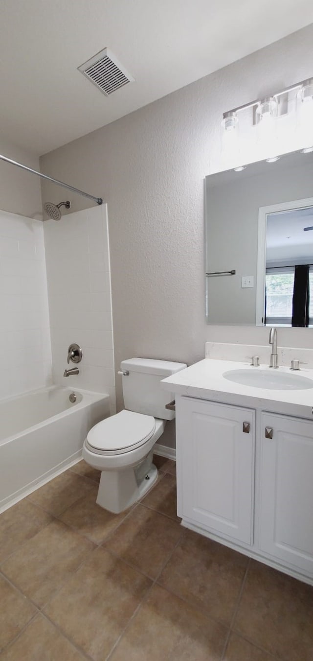 full bathroom featuring tile patterned flooring, vanity, shower / bath combination, and toilet