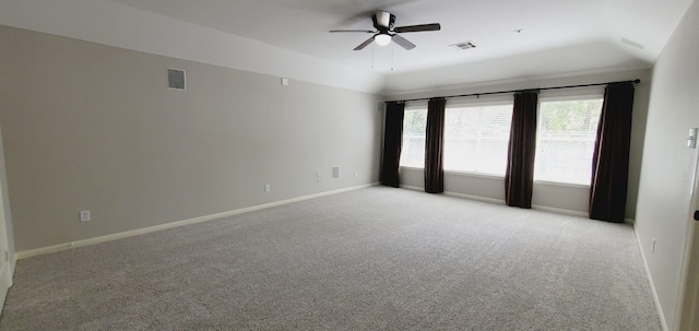 carpeted empty room featuring vaulted ceiling and ceiling fan