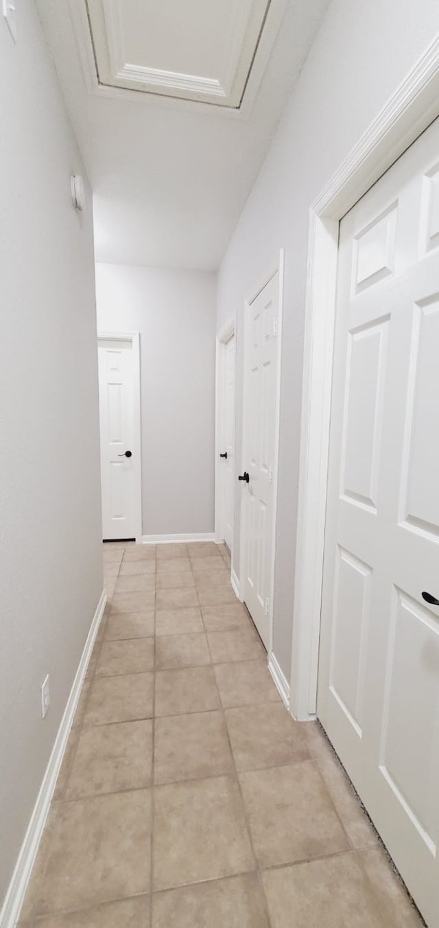 hallway featuring light tile patterned floors