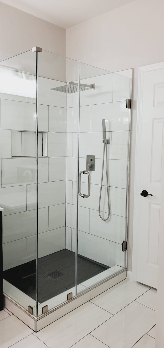 bathroom featuring tile patterned floors and an enclosed shower