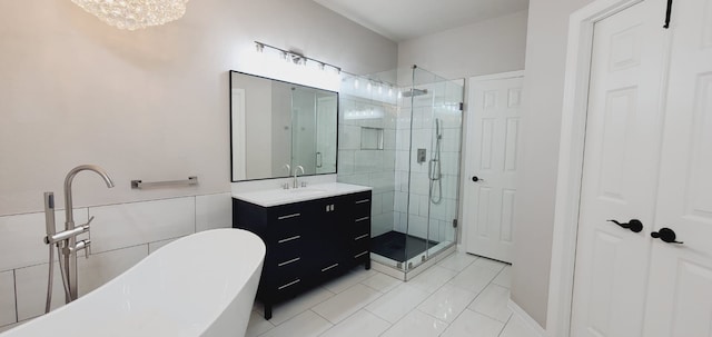 bathroom with tile patterned floors, vanity, plus walk in shower, and a chandelier