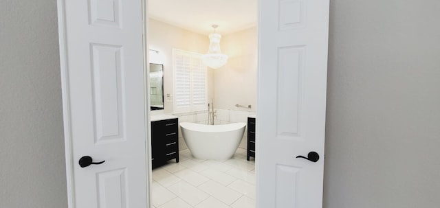 bathroom featuring a bathing tub, vanity, tile patterned floors, and tile walls