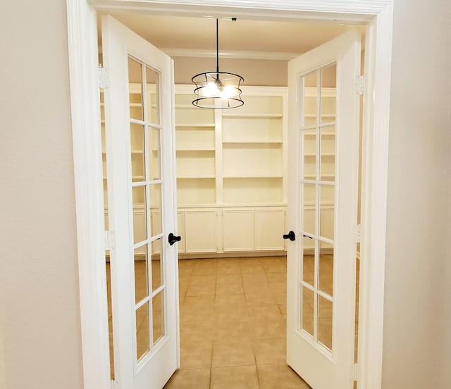 interior space with a chandelier, light tile patterned floors, and french doors