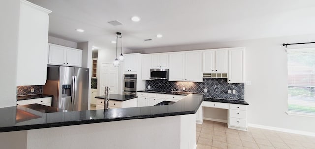 kitchen featuring white cabinets, appliances with stainless steel finishes, and decorative backsplash