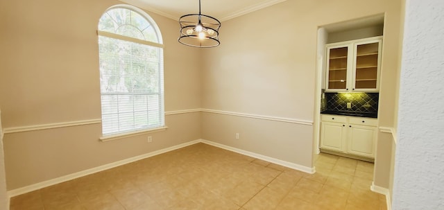 unfurnished dining area with light tile patterned floors and crown molding