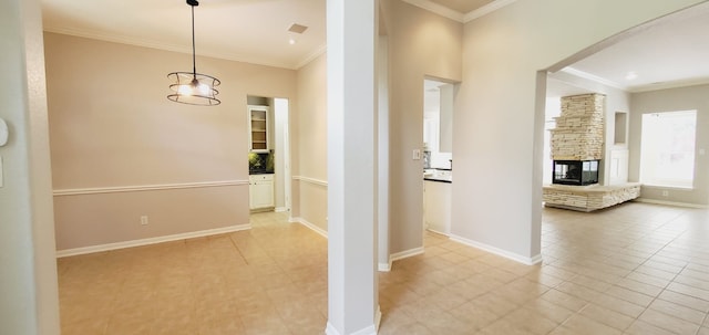 hallway with crown molding and light tile patterned floors