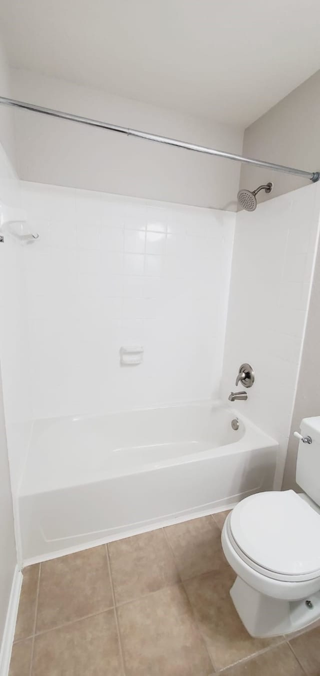 bathroom featuring tile patterned floors, bathing tub / shower combination, and toilet