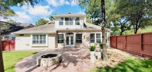 back of house with french doors, a patio, and a fire pit