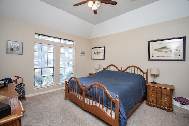 bedroom with ceiling fan, light colored carpet, and vaulted ceiling