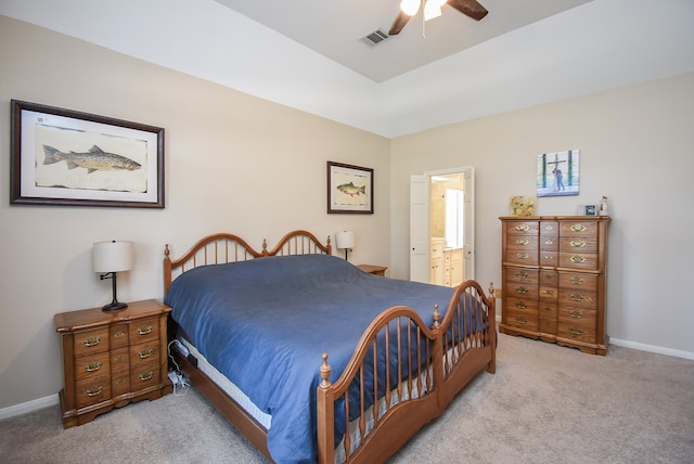 bedroom featuring connected bathroom, ceiling fan, and light colored carpet