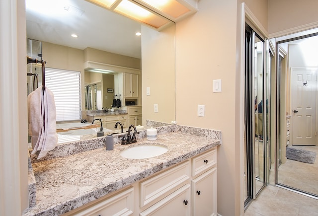 bathroom with vanity and tile patterned floors