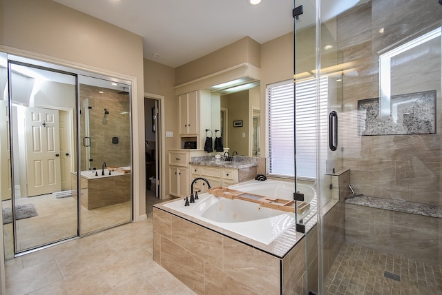 bathroom featuring tile patterned floors, vanity, and plus walk in shower