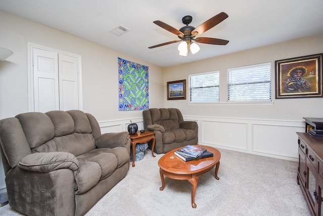 living room featuring light colored carpet and ceiling fan