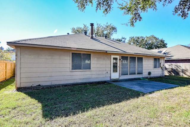 back of property featuring a patio area and a lawn