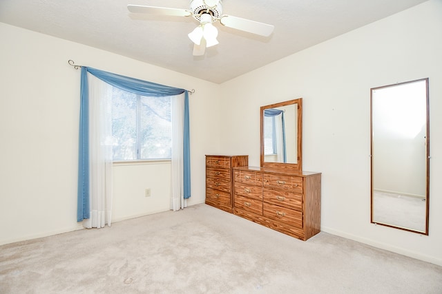 unfurnished bedroom featuring light carpet and ceiling fan