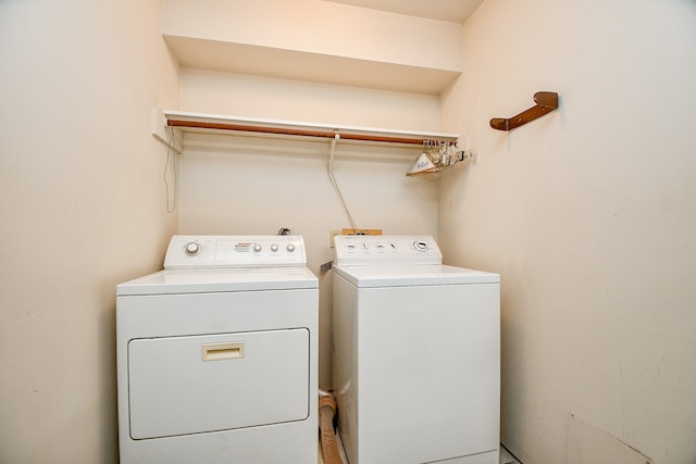 clothes washing area featuring washer and dryer