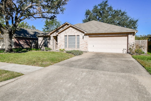 single story home featuring a garage and a front lawn