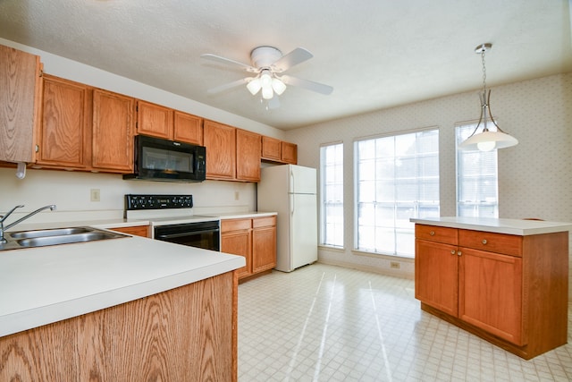 kitchen featuring white appliances, a textured ceiling, ceiling fan, sink, and hanging light fixtures