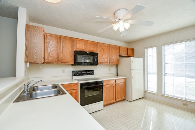 kitchen featuring a textured ceiling, ceiling fan, sink, and white appliances