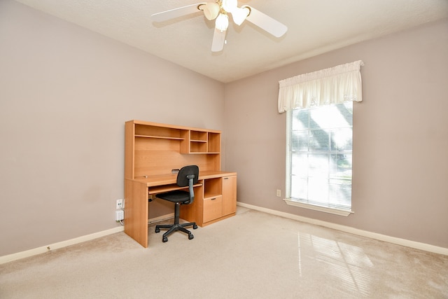 carpeted office with ceiling fan and a healthy amount of sunlight