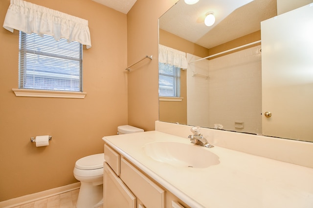 bathroom with walk in shower, vanity, a textured ceiling, and toilet