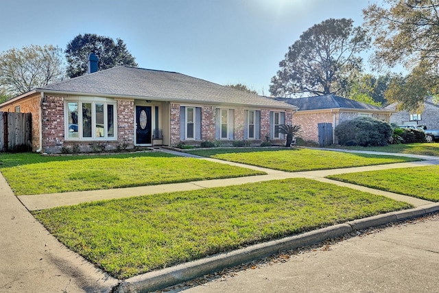 ranch-style home featuring a front yard