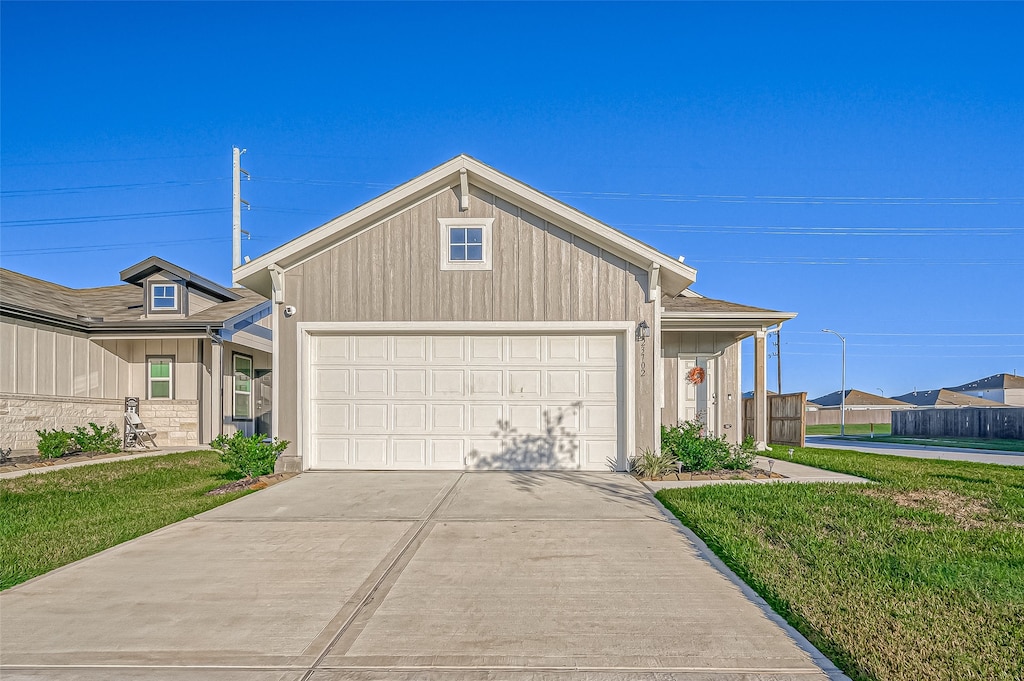 view of front of house with a front yard and a garage