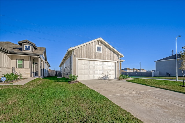 view of home's exterior with a yard, a garage, and central AC unit