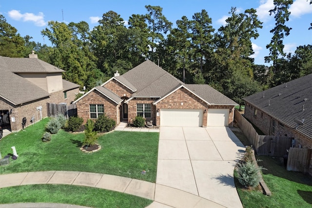 view of front of home with a garage and a front lawn