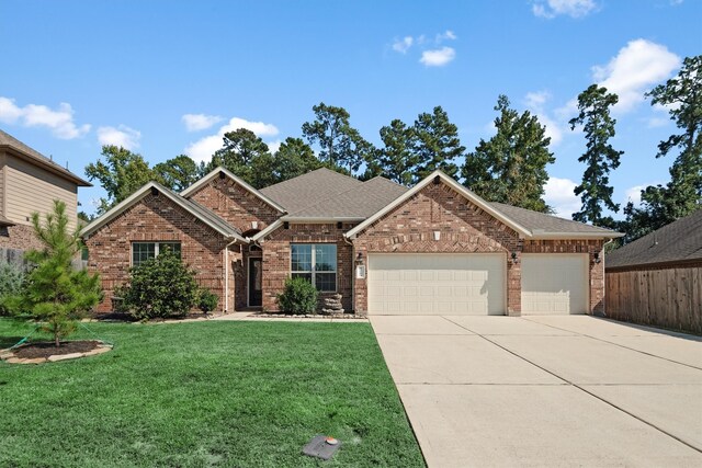 view of front of property featuring a front yard and a garage