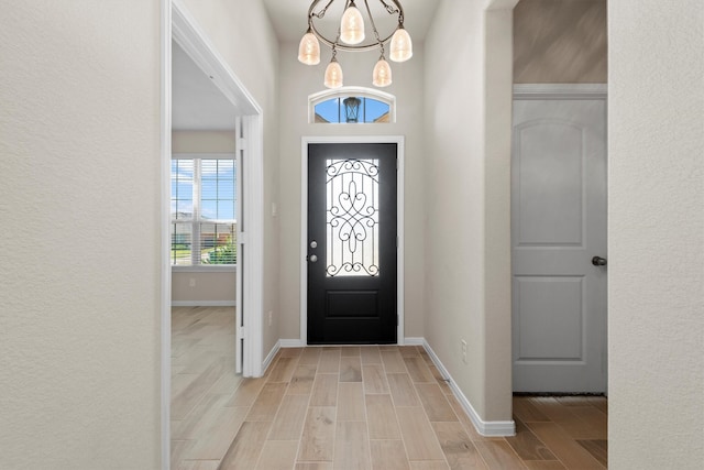 entryway featuring a notable chandelier and light hardwood / wood-style floors