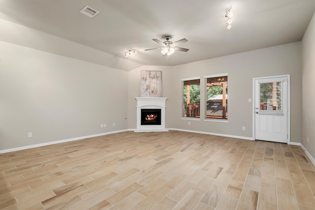 unfurnished living room featuring ceiling fan and light wood-type flooring