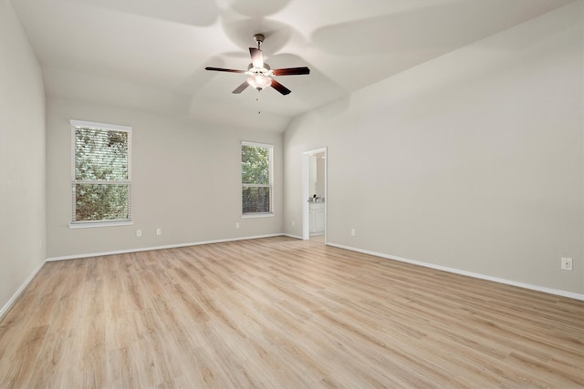 spare room with ceiling fan, light hardwood / wood-style floors, and vaulted ceiling