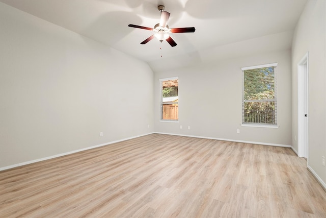 empty room with ceiling fan, lofted ceiling, and light wood-type flooring