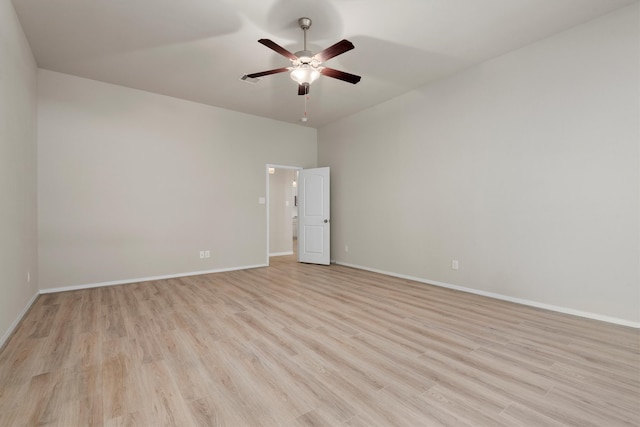 empty room with ceiling fan and light hardwood / wood-style flooring