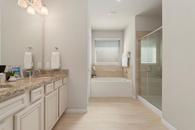 bathroom featuring plus walk in shower, vanity, and tile patterned floors