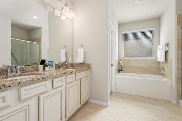 bathroom featuring vanity and shower with separate bathtub