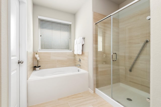 bathroom featuring shower with separate bathtub and hardwood / wood-style flooring