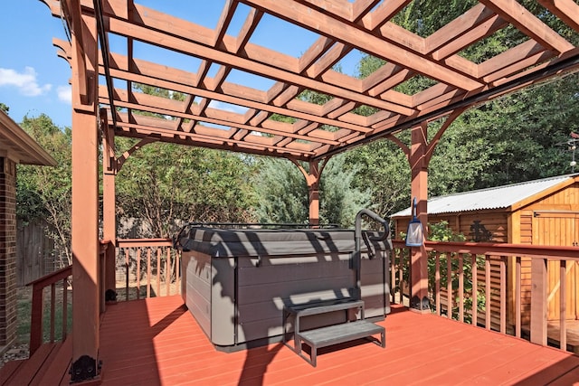 wooden deck with a pergola, a hot tub, and a shed