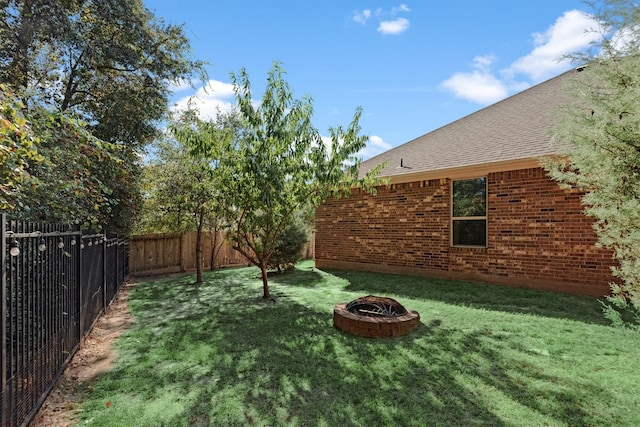 view of yard with an outdoor fire pit