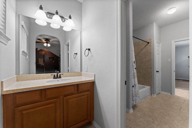 bathroom with vanity, ceiling fan, and shower / bath combo with shower curtain