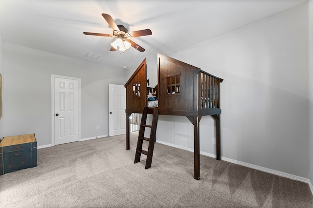 interior space with carpet flooring and ceiling fan