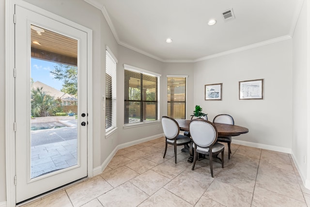 tiled dining space featuring crown molding