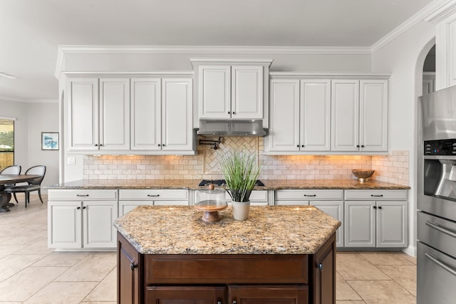 kitchen with white cabinetry, crown molding, a kitchen island, and stainless steel appliances