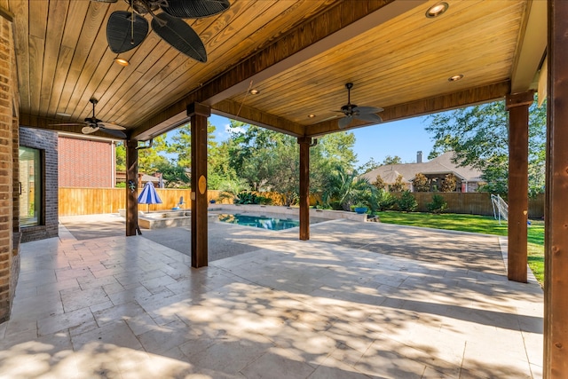 view of patio / terrace with a fenced in pool and ceiling fan