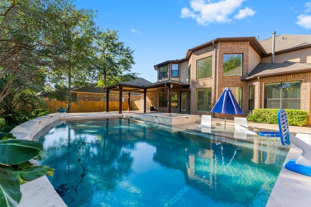 view of swimming pool with a jacuzzi