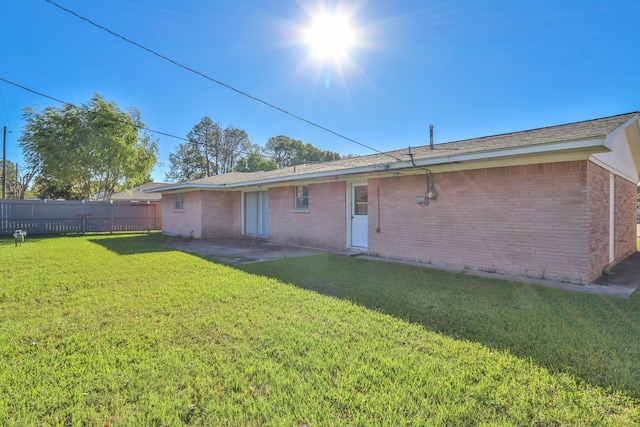 back of property featuring a yard