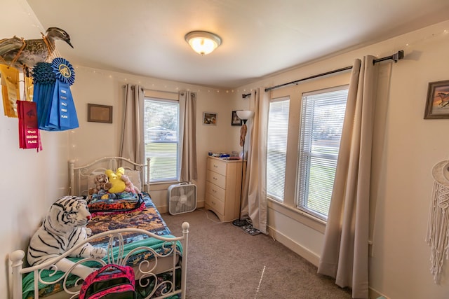 carpeted bedroom featuring multiple windows